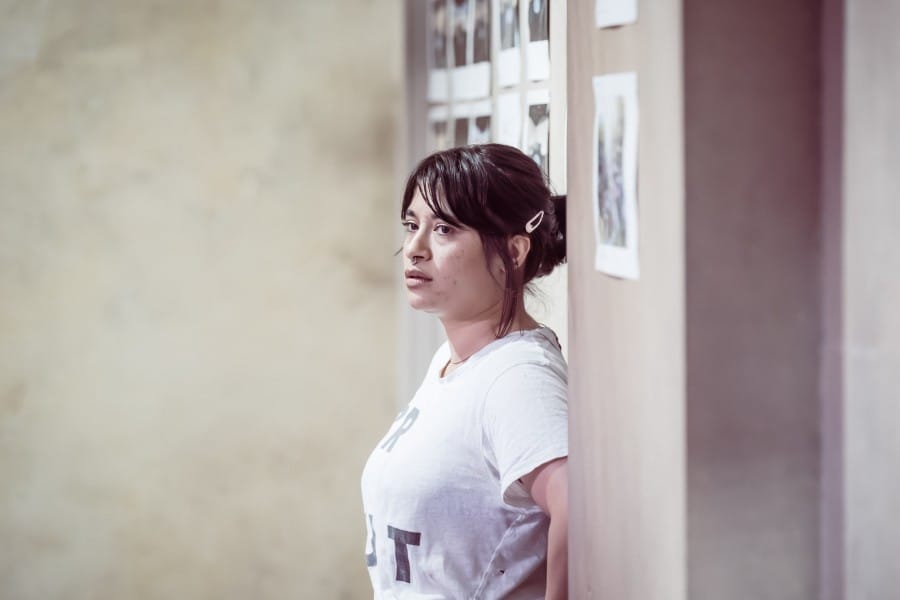 Peyvand leaning on the rehearsal room wall