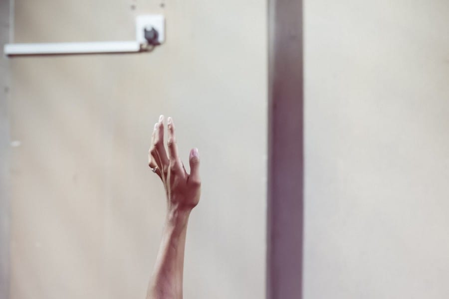 Miles facing away from the camera holding one arm up into the air