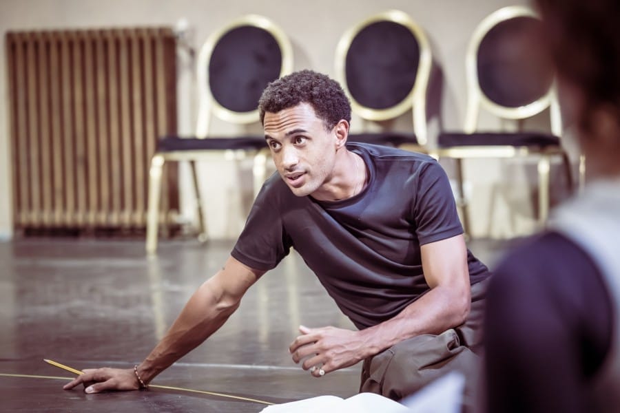 Miles, seated on the floor with his script next to him